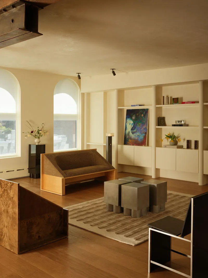 Living area with arched windows and burled wood furniture under painted ceiling