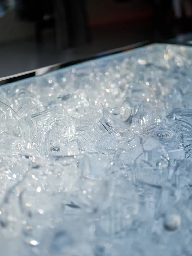 Close-up of translucent textured glass surface with molded organic patterns catching light