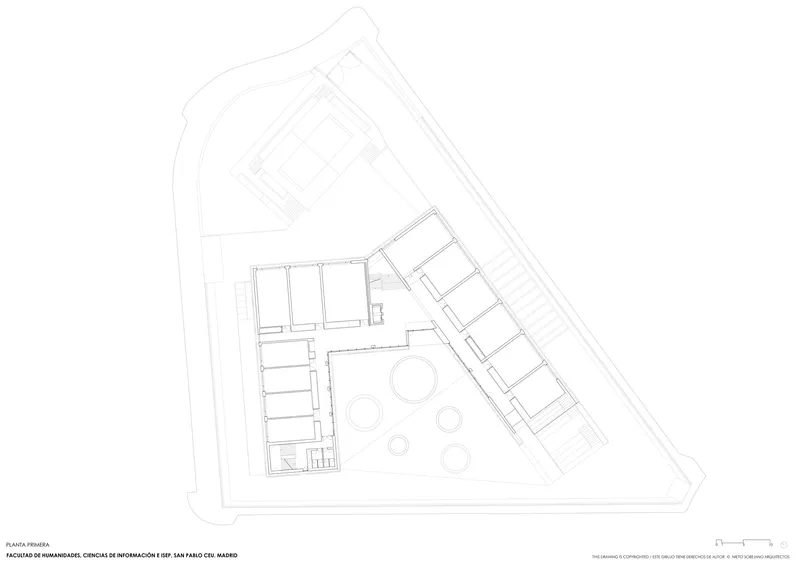 First floor plan drawing showing circular elements in the courtyard connecting two angled building volumes