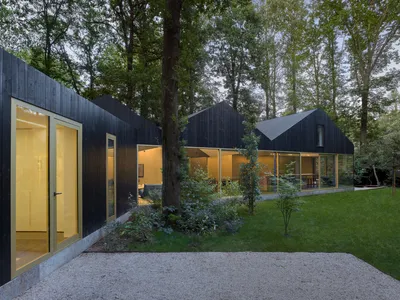 BASIL Architecture Weaves a Charred Timber House Between the Oak Trees of a Belgian Garden