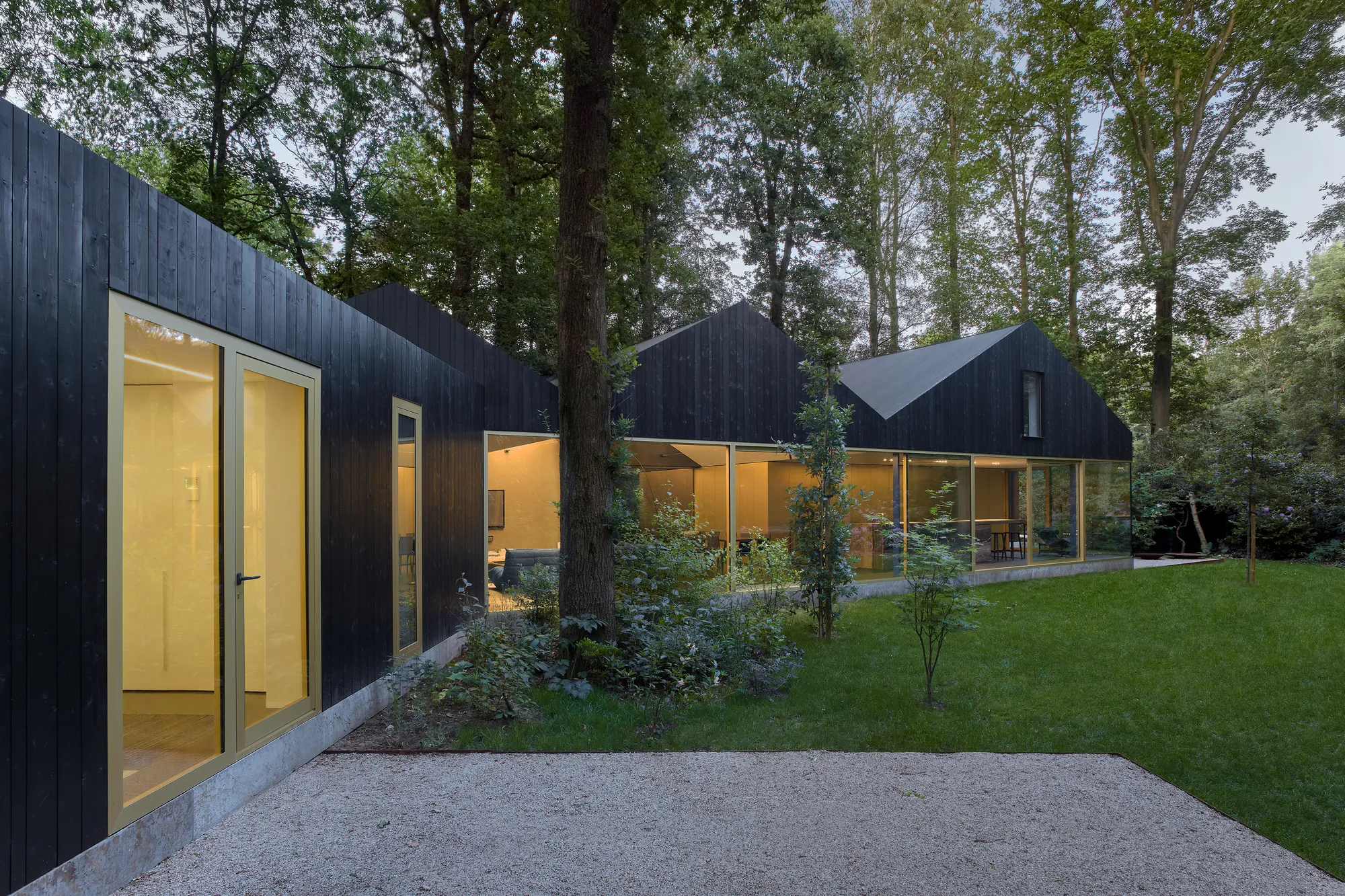 BASIL Architecture Weaves a Charred Timber House Between the Oak Trees of a Belgian Garden
