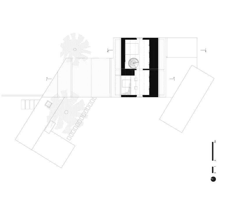 Floor plan drawing depicting upper-level layout with central spiral staircase and angled wings