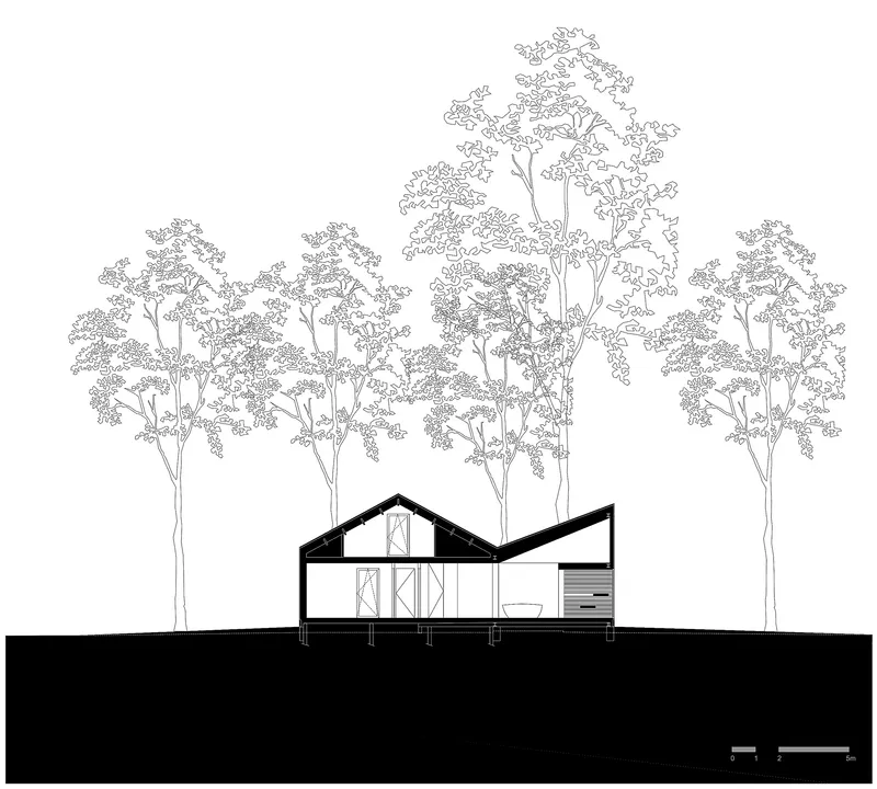 Section drawing showing timber framing and interior layout under a pitched roof surrounded by trees