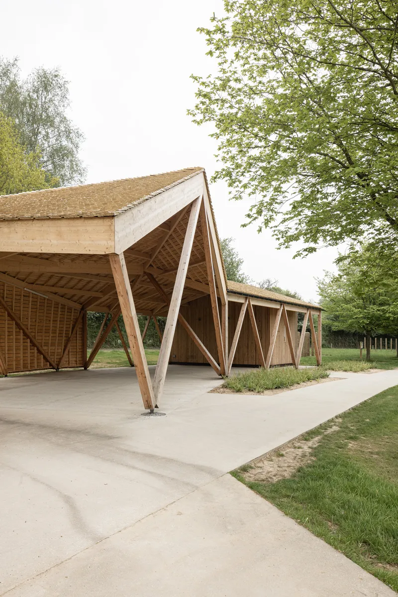 Detail of the pavilion's angled timber columns and woven lattice infill beneath the overhanging roof