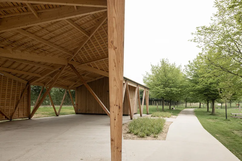 View from beneath the exposed timber roof structure showing diagonal bracing and lattice screen wall
