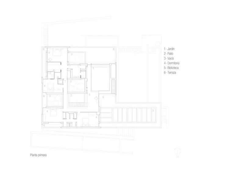 Ground floor plan drawing showing a residential layout with courtyards, library, and terrace spaces