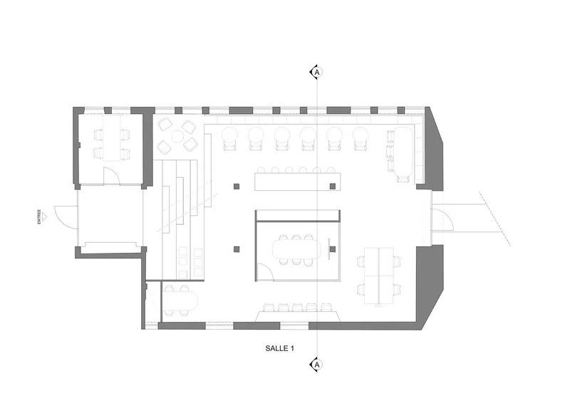 Floor plan drawing showing an open workspace layout with central meeting room and perimeter desks