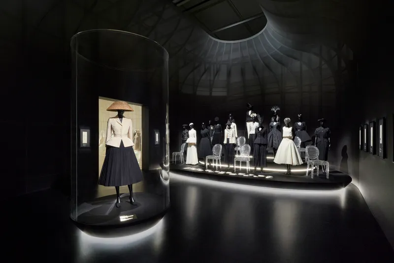 Cylindrical display vitrine with spot lighting in a dark circular gallery space