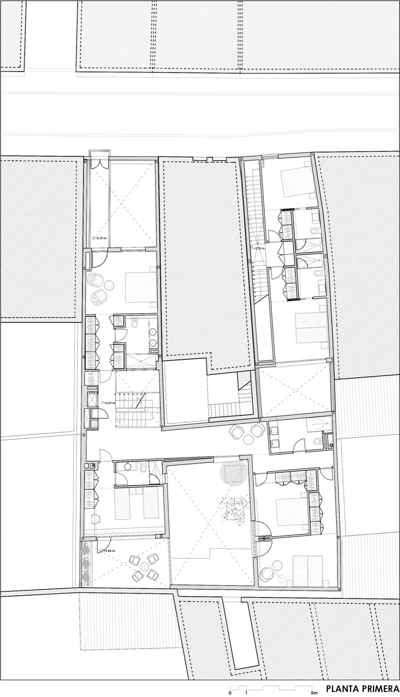 First floor plan drawing showing bedrooms, bathrooms, and terraces arranged around a central courtyard
