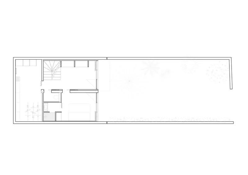 Floor plan drawing showing a narrow rectangular layout with stair, service rooms, and large open space