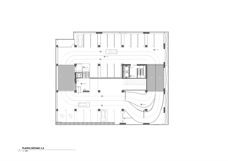 Floor plan showing basement level with curved ramps flanking a central core and elevator bank