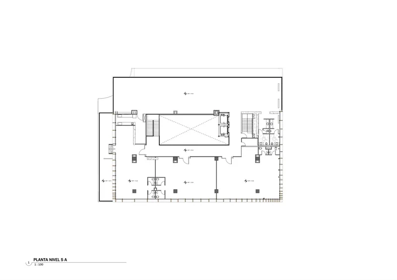 Floor plan drawing showing a large central hall surrounded by smaller rooms with multiple stair cores