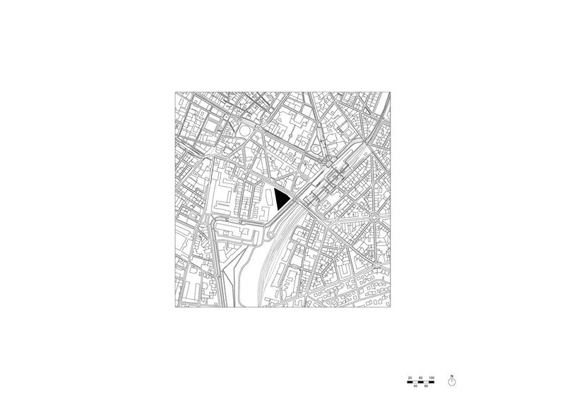 Site plan drawing showing a triangular building footprint marked in black within the surrounding urban street grid