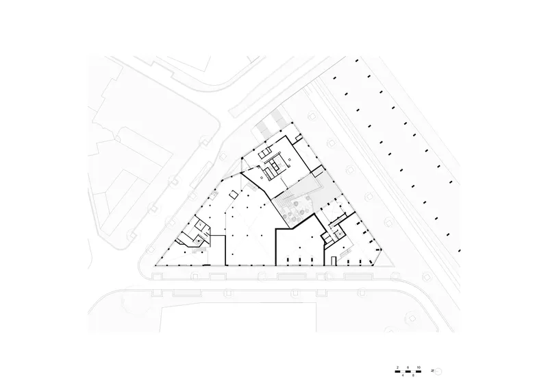 Ground floor plan drawing showing the triangular building with central courtyard and perimeter circulation spaces