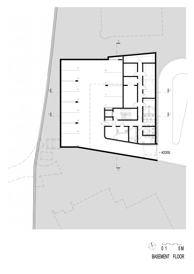 Basement floor plan showing a large open space with service rooms and access point along the angled perimeter