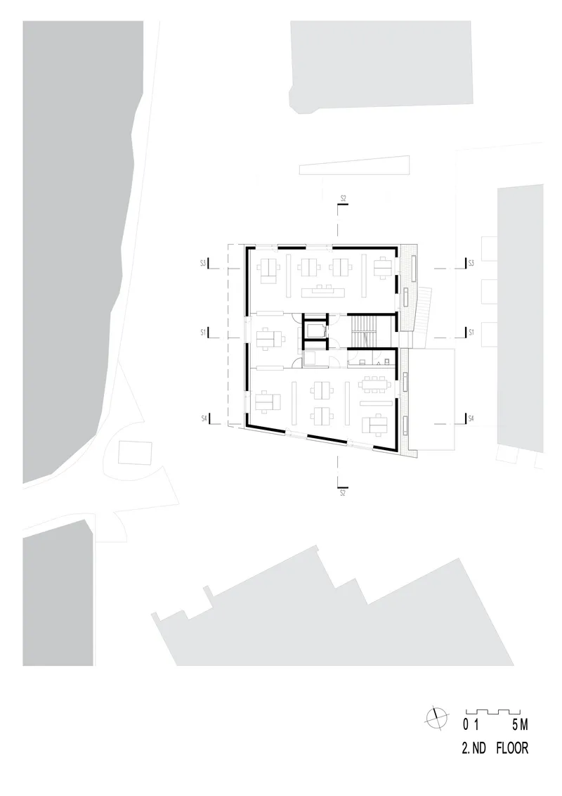 Second floor plan showing open living spaces and central stairwell with surrounding terraces