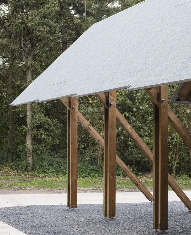 Detail of the diagonal timber bracing connecting columns beneath the overhanging roof plane