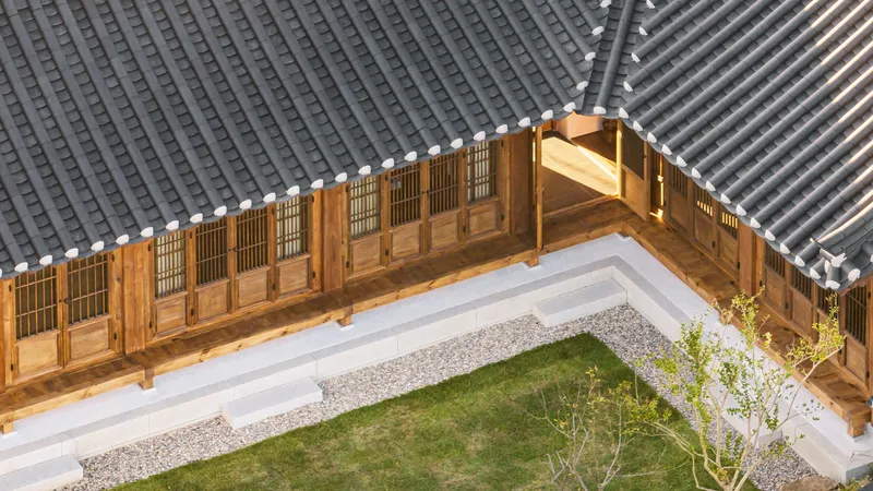 Aerial view of timber verandah with lattice panels enclosing a courtyard with grass lawn and young tree