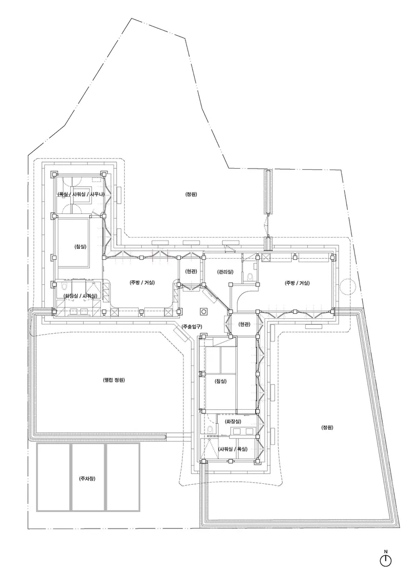 Floor plan drawing showing an L-shaped residence with labeled rooms arranged around a central cross-shaped circulation core