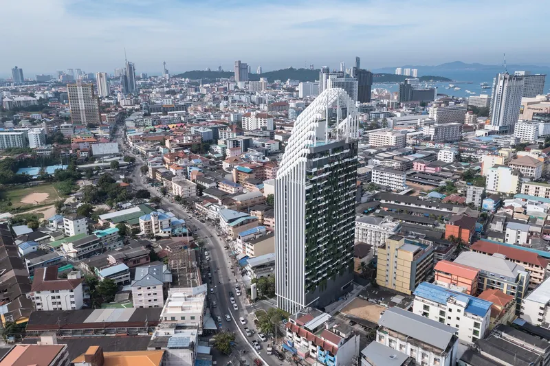 Aerial view of the tower rising above surrounding low-rise urban fabric with the bay in the distance