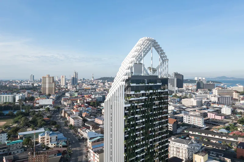 Aerial view showing planted balconies on the dark podium beneath the pointed white exoskeleton crown