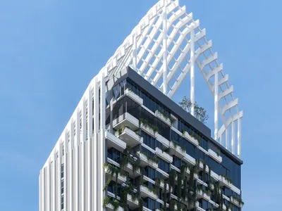 Architects 49 Wraps a 23-Story Pattaya Tower in Vertical Fins and Living Greenery