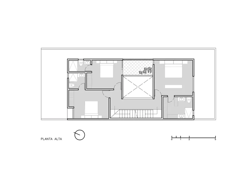 Upper floor plan with two bedrooms and a bathroom arranged around a central double-height void