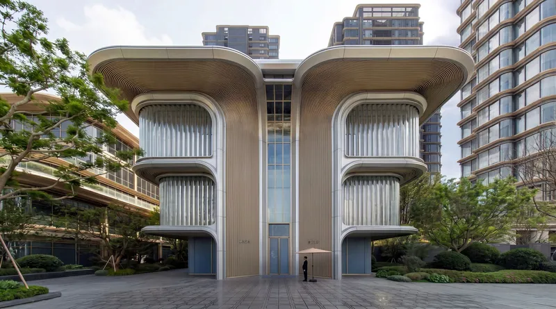 Symmetrical facade with vertical ribbed screens and curved overhangs flanking a glazed central tower under cloudy skies
