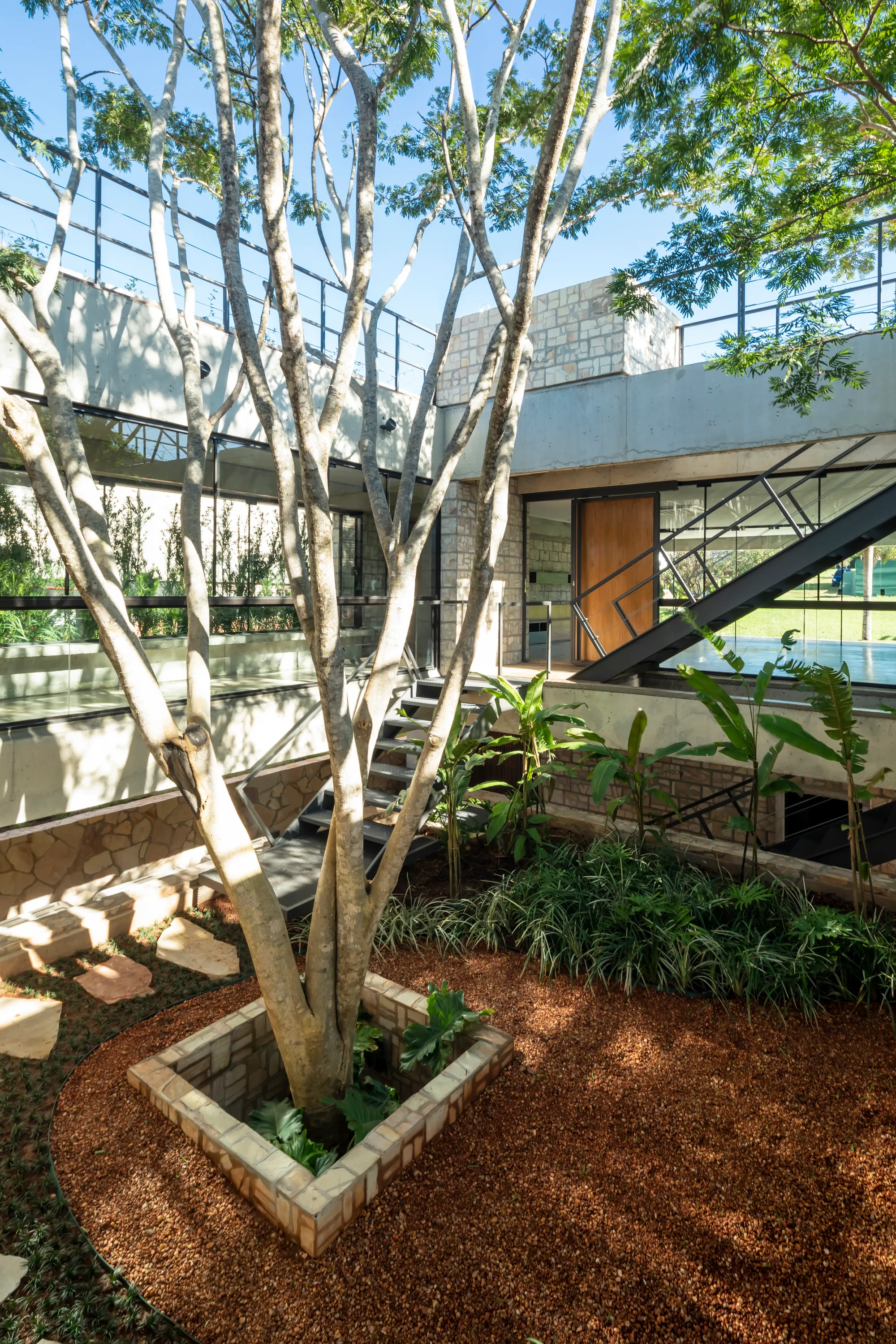 OMCM arquitectos Builds a Summer House in Paraguay from Quarry Waste Blocks and Three Sacred Trees