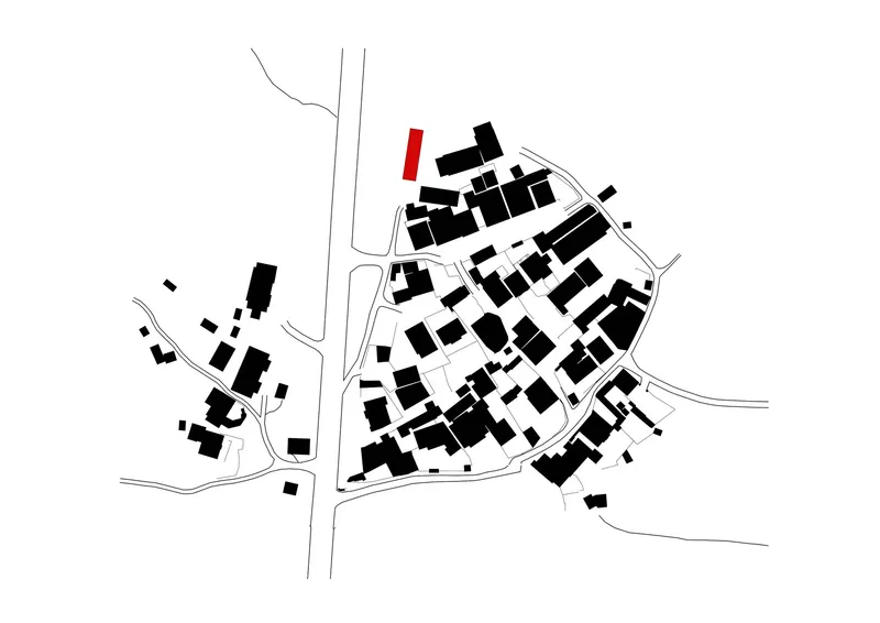 Site plan drawing showing building footprints in black with one highlighted in red