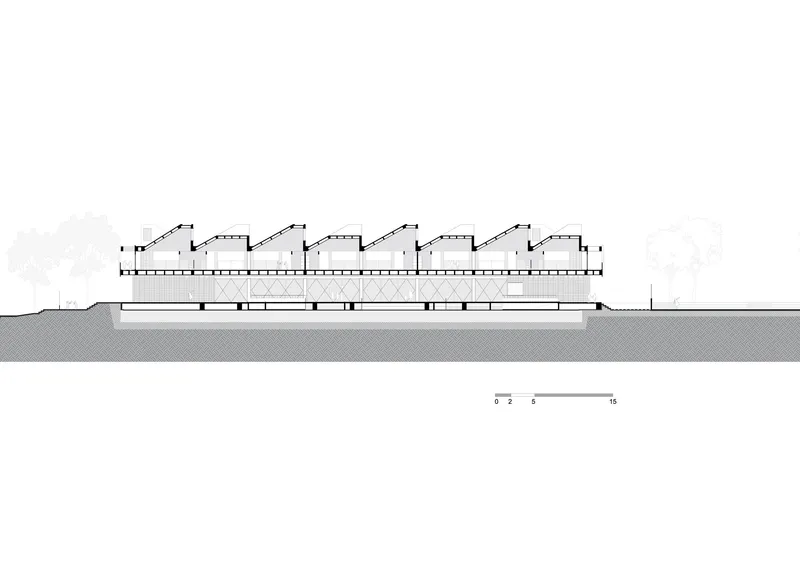 Section drawing illustrating a horizontal volume with four repetitive sawtooth roof monitors above ground level