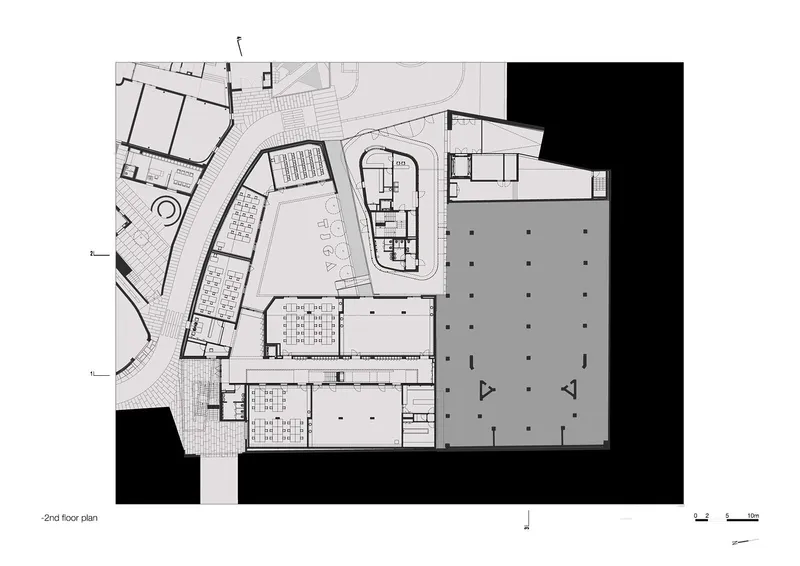 Second floor plan drawing showing auditorium, corridors, parking area, and adjacent volumes