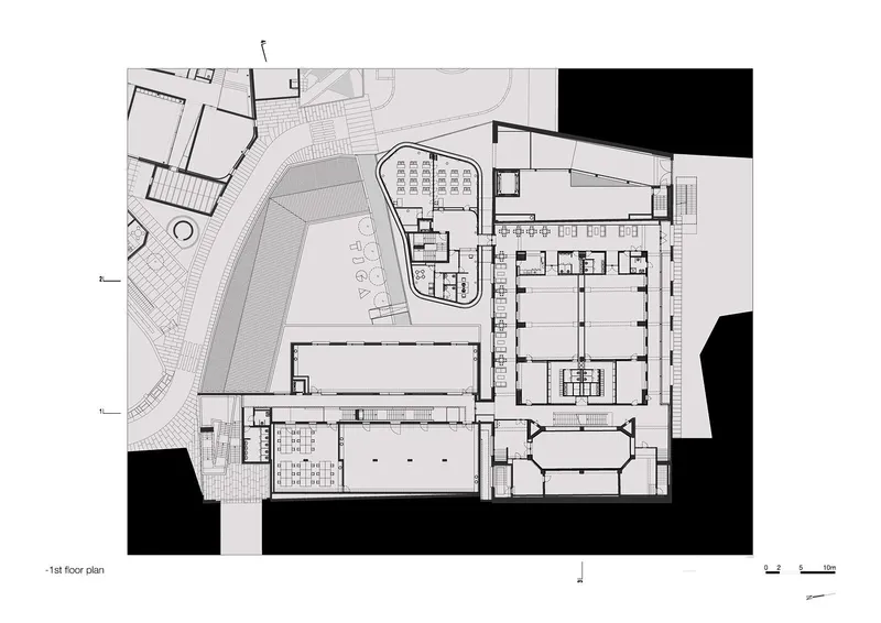 First floor plan showing courtyard, auditorium block, and adjacent structures with landscaped surroundings