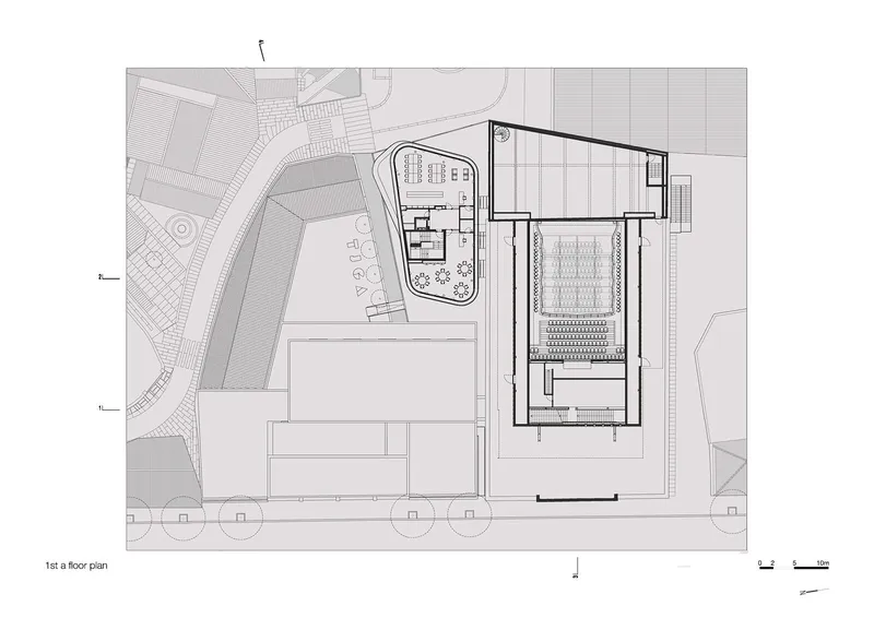 First subterranean floor plan showing reduced building footprint with performance hall and curved courtyard structure