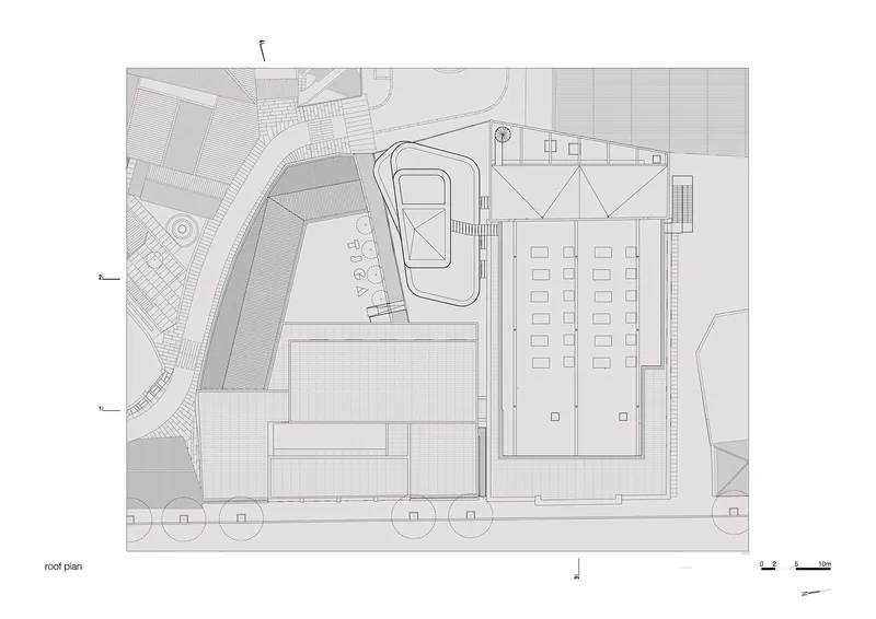 Roof plan drawing showing triangular skylight structure above main hall and organic-shaped courtyard pavilion roof