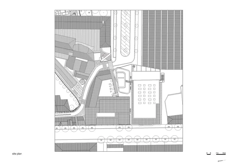 Site plan drawing showing building footprints, street grid, and surrounding paving patterns