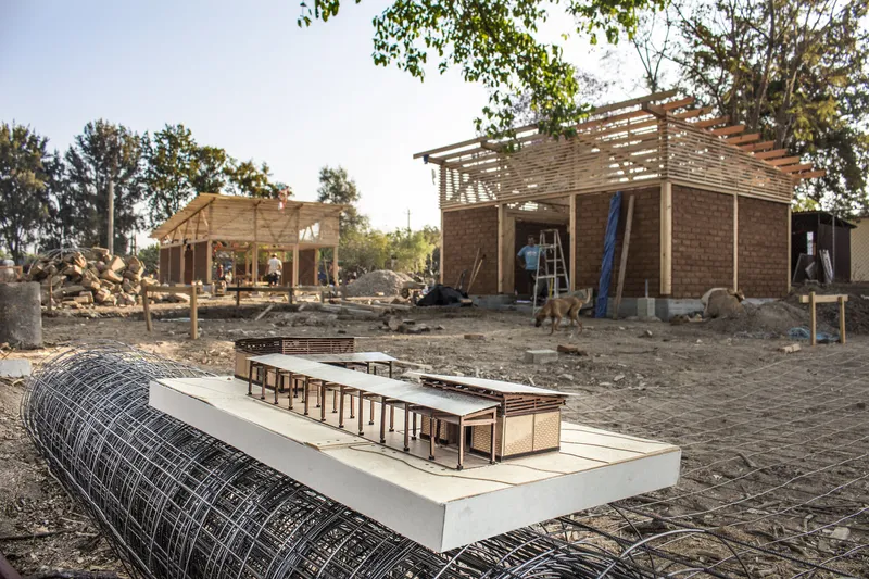 Physical model on the construction site showing timber frame structure and interior layout