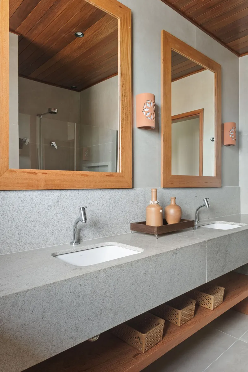 Double vanity with terrazzo countertop beneath timber-framed mirrors and a slatted timber ceiling above