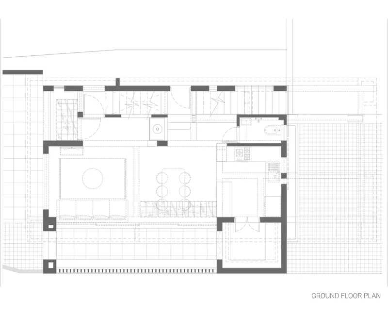 Ground floor plan drawing showing living and dining areas with outdoor terrace on grid