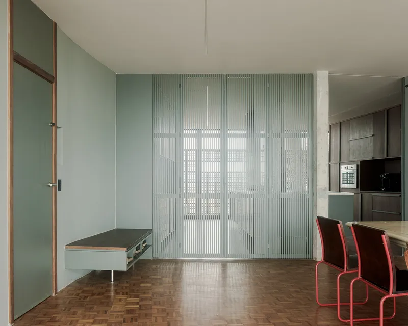 Translucent fluted glass wall system with integrated doorway and fold-down bench seat