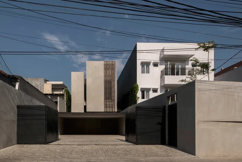 Street view of the concrete facade with vertical timber screening and overhead power lines