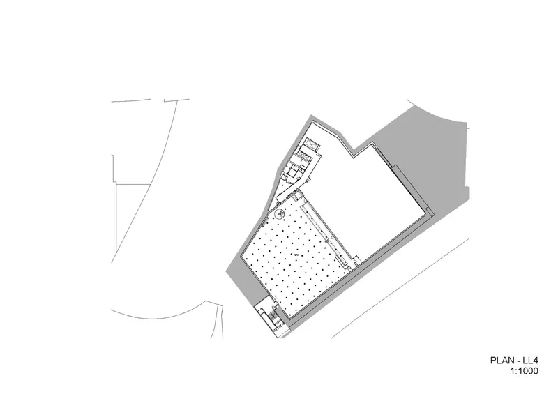 Floor plan drawing of level four showing an auditorium space with angled seating grid and service areas