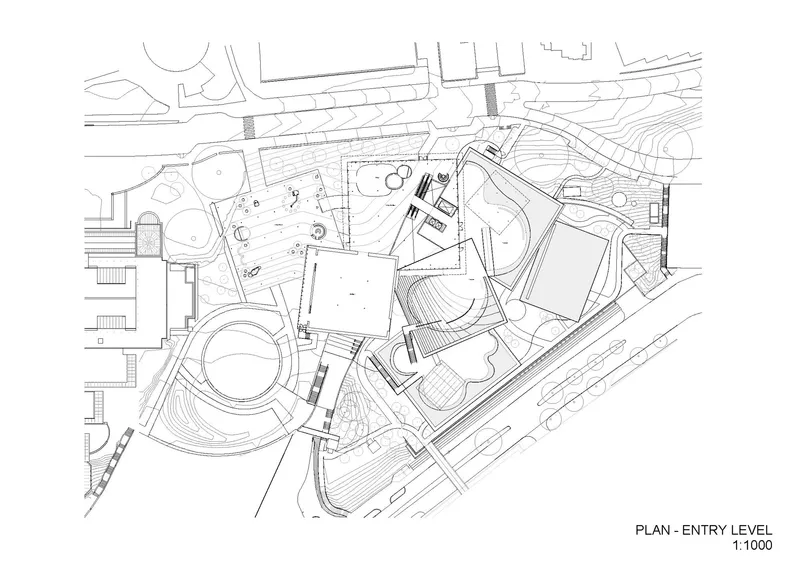Entry level floor plan drawing showing irregular building volumes around landscaped terraces and circulation paths