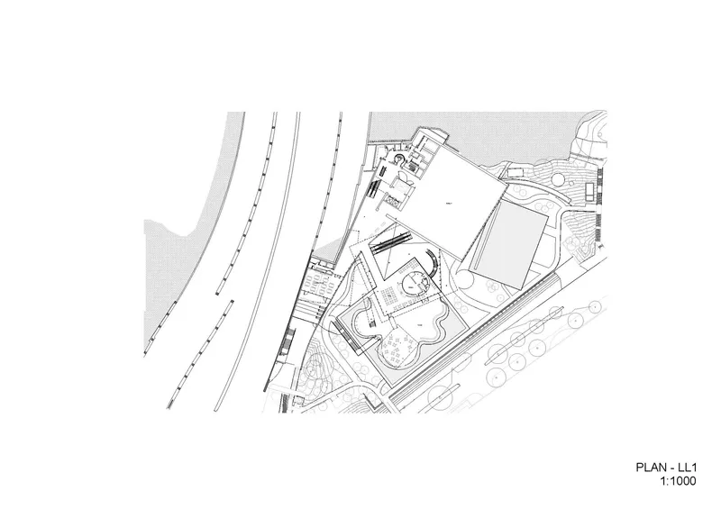Floor plan drawing of level one showing angular volumes adjacent to railway tracks and waterfront edge