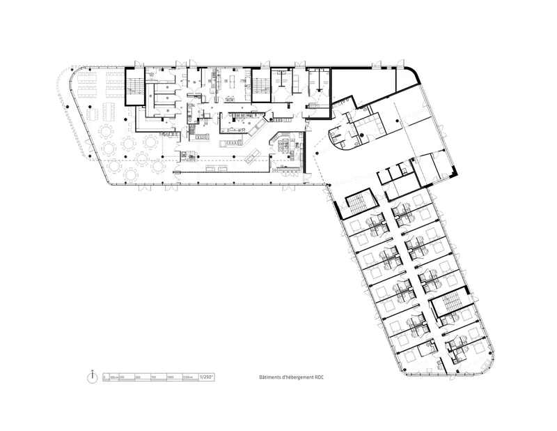 Floor plan drawing showing an L-shaped layout with terraces, multiple rooms, and circulation cores