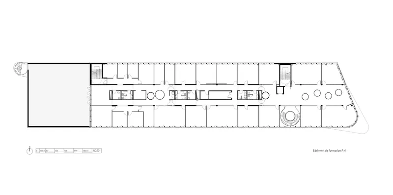 Floor plan drawing displaying a long linear bar with repeating rooms and a circular central element