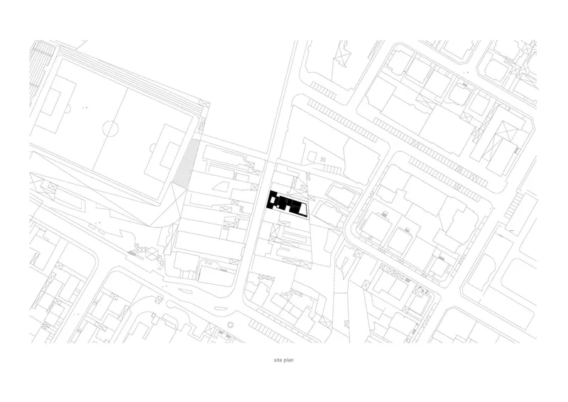 Site plan drawing showing single building footprint in black within the surrounding urban block