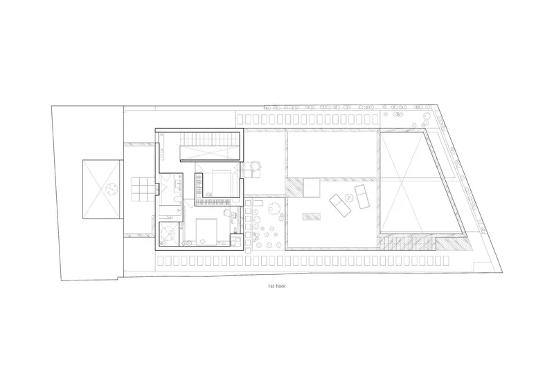 First floor plan drawing showing open living space with triangular skylights and central staircase