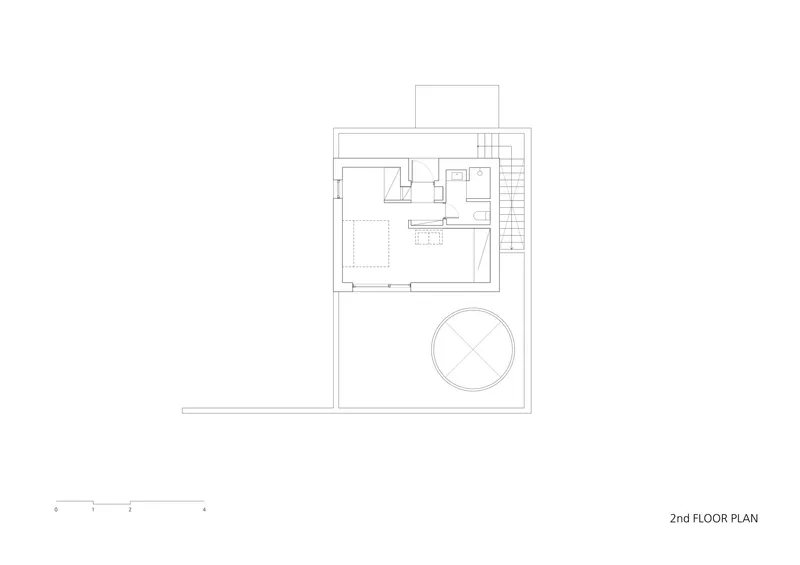 Second floor plan drawing showing bedroom suite with bathroom and circular feature in courtyard
