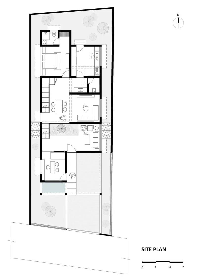 Site plan drawing showing a narrow dwelling with internal courtyard and two staircases